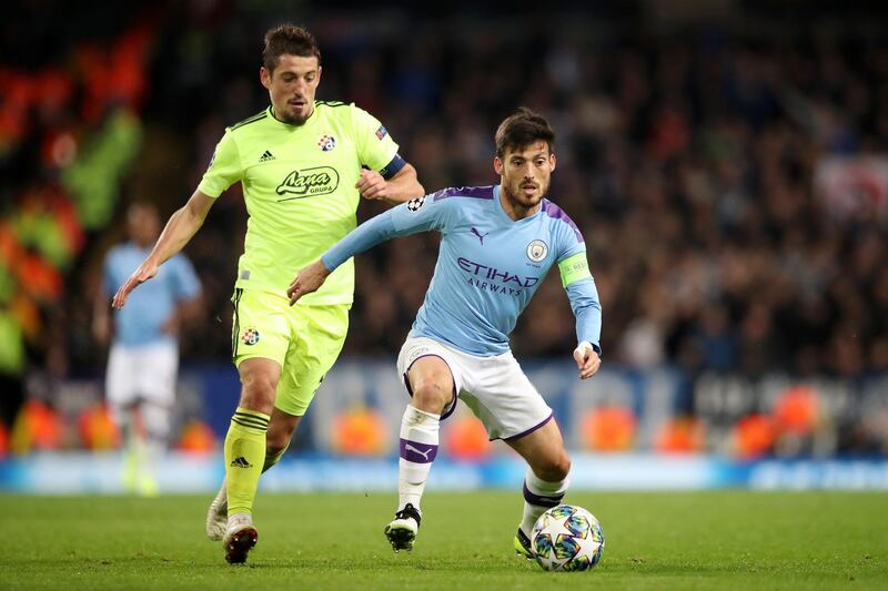 Manchester City midfielder David Silva fends off a challenge from Arijan Ademi. Getty Images