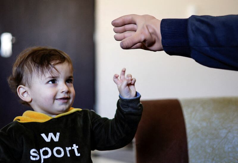 The 'smart' prosthetic hand mimics human anatomy and motion has allowed Ahmed Abu Hamda to play with his children at their home in Gaza Strip.