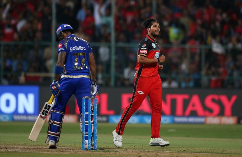 Royal Challengers Bangalore's Umesh Yadav, right, celebrates the dismissal of Mumbai Indians' Suryakumar Yadav, left, during the VIVO IPL Twenty20 cricket match in Bangalore, India, Tuesday, May 1, 2018. (AP Photo/Aijaz Rahi)