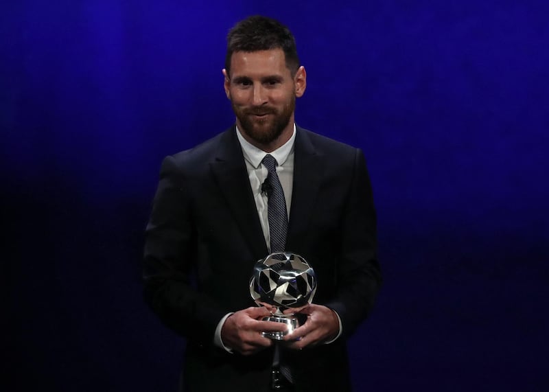 Messi receives his trophy for Uefa Forward of the Year. AFP