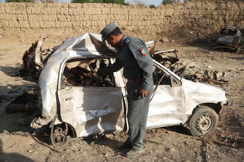 epa08717491 An Afghan security personnel inspects the site of bomb attack which targeted a National Directorate of Security (NDS) office in Jalalabad, Afghanistan, 03 October 2020. At least 15 people were killed and 42 persons injured after armed men targeted NDS office with a car bomb and gunfight.  EPA/GHULAMULLAH HABIBI