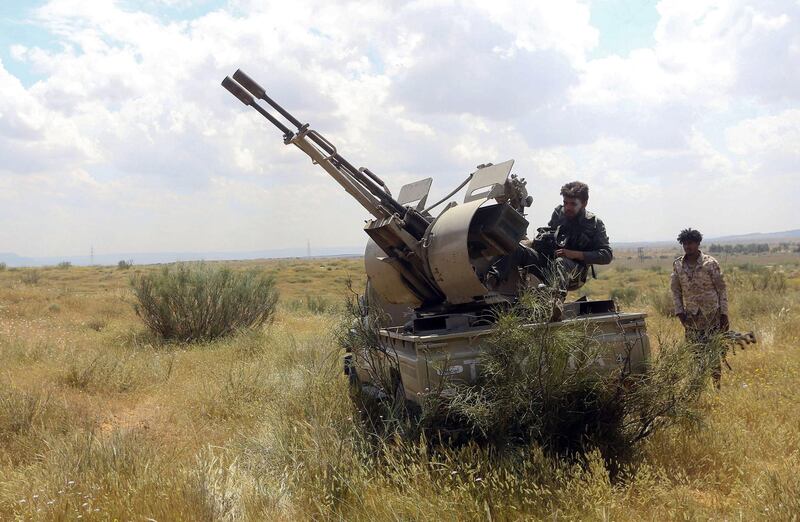 Fighters loyal to Libya's Government of National Accord hold a position west of the city of Aziziah. AFP