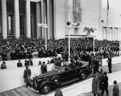30th April 1939:  From his car drawn up at the entrance, President Roosevelt (1882 - 1945) waves to the crowds at the opening of the World Fair, New York.  (Photo by Fox Photos/Getty Images)