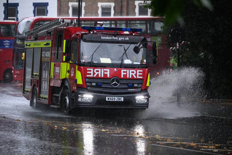 A fire engine negotiates a flooded section of road in London. Getty