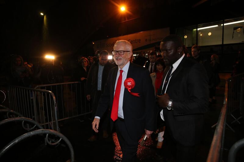 Britain's opposition Labour Party leader Jeremy Corbyn (C) leaves after being relected to his seat of Islington North at the count centre in Islington, north London, on December 13, 2019 after votes were counted as part of the UK general election.  Jeremy Corbyn on Friday said he would not lead Britain's main opposition Labour party at the next general election, after predictions of a crushing defeat at nationwide polls. / AFP / ISABEL INFANTES
