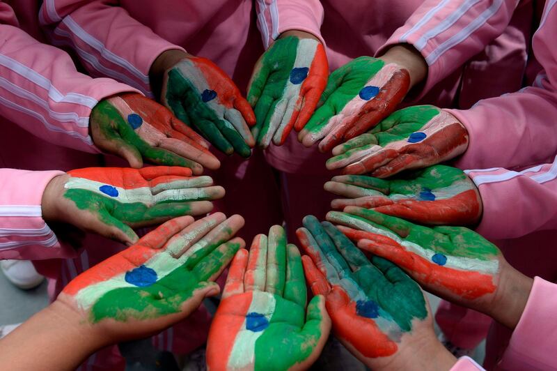 Students display their hands painted the colours of the Indian national flag as they take part in Independence Day celebrations at Saint Francis Girls High School in Secunderabad, the twin city of Hyderabad.  AFP