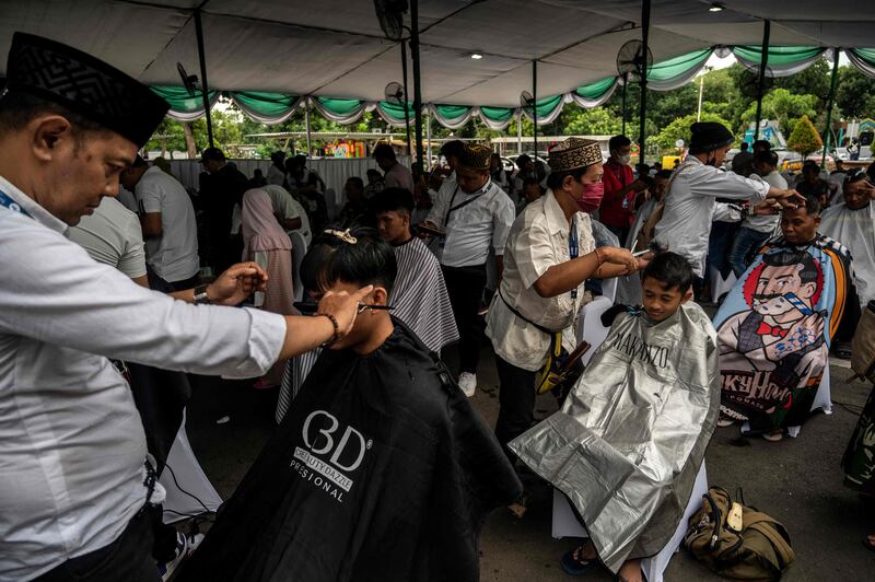 A mass haircut outside Al Akbar Mosque in Surabaya, Indonesia, on the eve of Ramadan. AFP