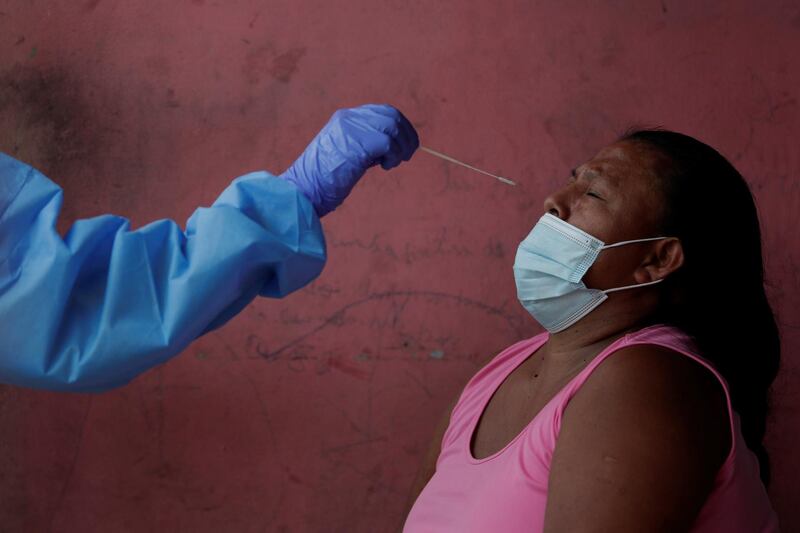 A health worker administrates a coronavirus test at Kuna Nega community in Panama City, Panama.  EPA