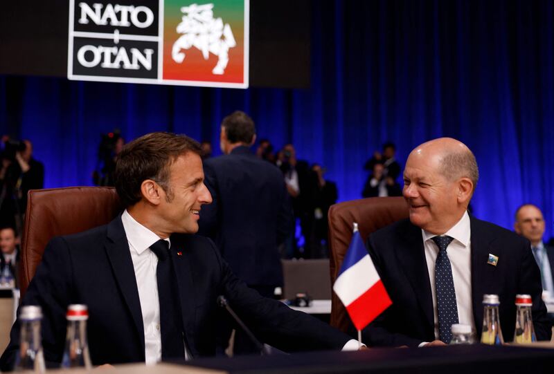 Mr Scholz speaks with French President Emmanuel Macron. AFP