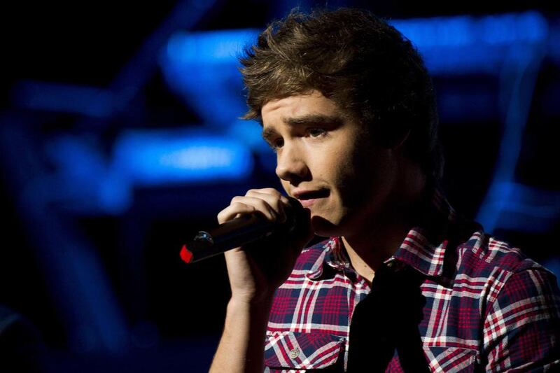 Liam Payne in concert, in New York on 15 January, 2014. He apologised to fans for being stupid and irresponsible after standing on the ledge of a high-rise with a city that appears to be London behind him. AP