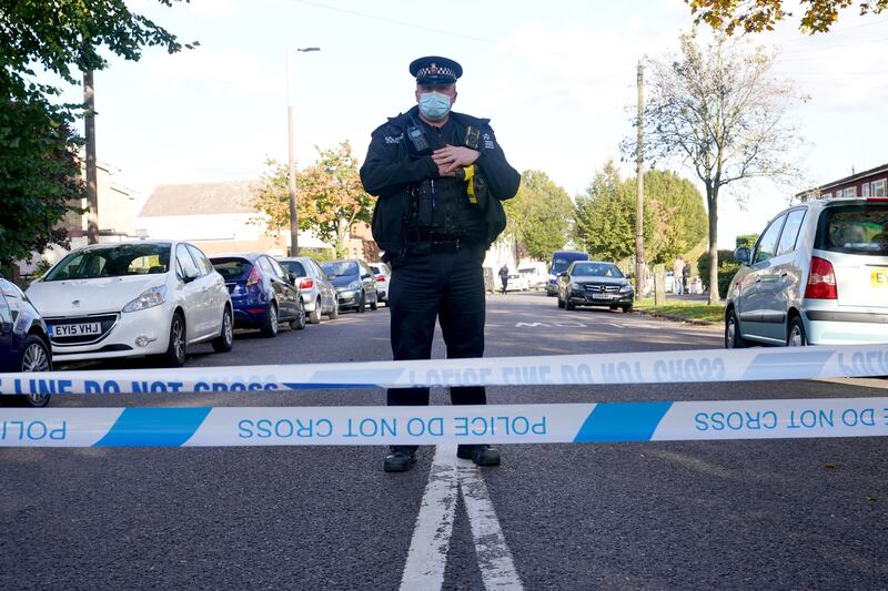 A police officer guards the scene. PA