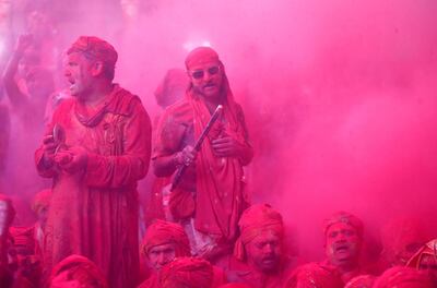 Men daubed in colours sing religious hymns as they celebrate "Lathmar Holi" inside a temple in the town of Barsana, in the northern state of Uttar Pradesh, India, March 15, 2019. REUTERS/Altaf Hussain