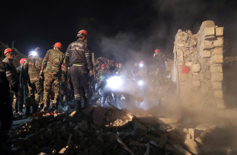 Azerbaijan rescuers work on the devastated houses allegedly damaged by recent shelling in Ganja.  EPA