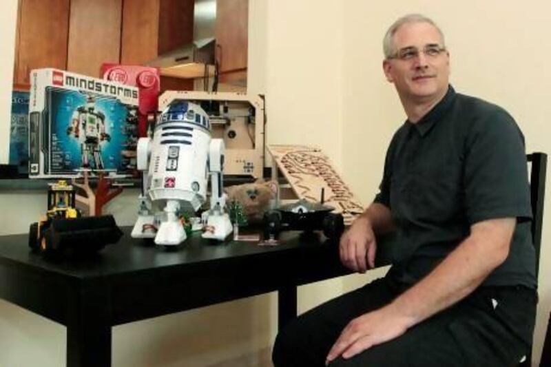 Paul Nagelkerke, who organises meetings of a new robotic club in Dubai, with a model of R2-D2 and other robots that he owns. Jeffrey E Biteng / The National