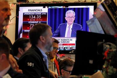 A television screen on the floor of the New York Stock Exchange shows Federal Reserve Board Chair Jerome Powell. Central bankers have injected more liquidity into financial markets. (AP Photo/Richard Drew)