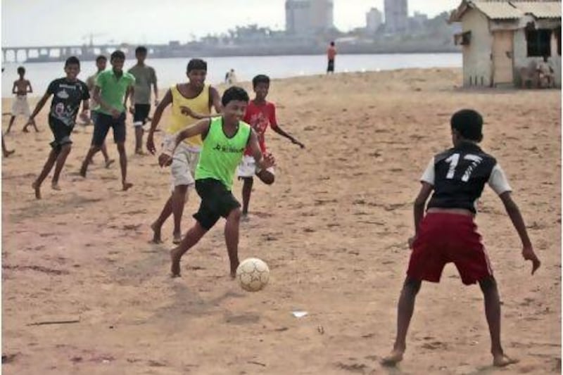 Indian children play football in Mumbai. AP Photo