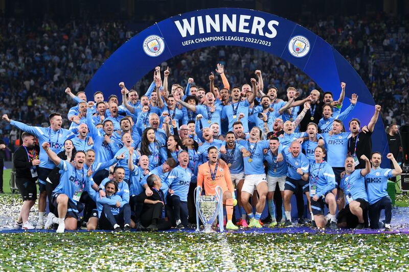 Manchester City players and staff celebrate with the Champions League trophy after their win over Inter Milan in the final on Saturday. Getty