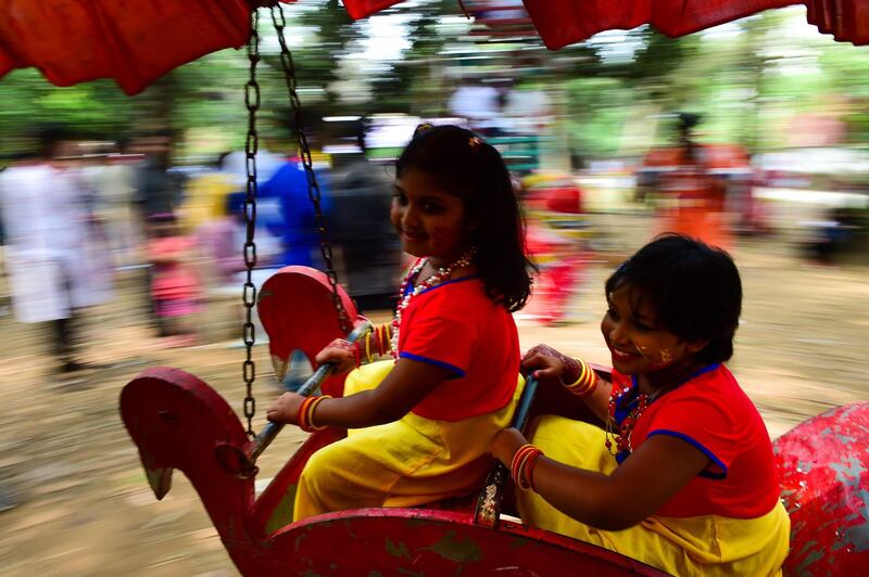 Bangladeshi children ride a merry-go-round as they celebrate the Bengali New Year or 'Pohela Boishakh' in Dhaka, Bangladesh. Munir Uz Zaman / AFP