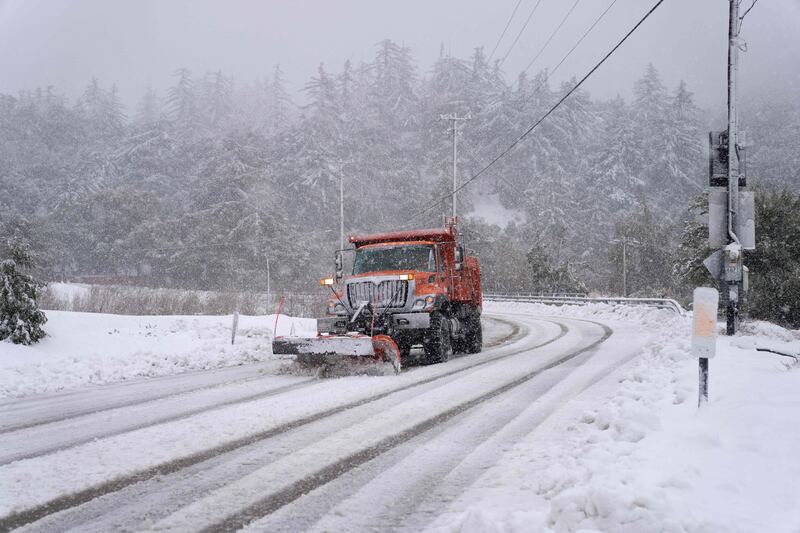 A plow clears snow in the town of Mount Baldy, California. AFP
