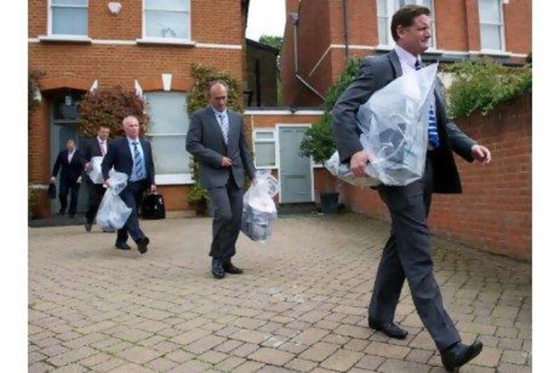 Plain clothes policemen yesterday removed evidence from the home of Andy Coulson, the former editor of the News of the World newspaper.