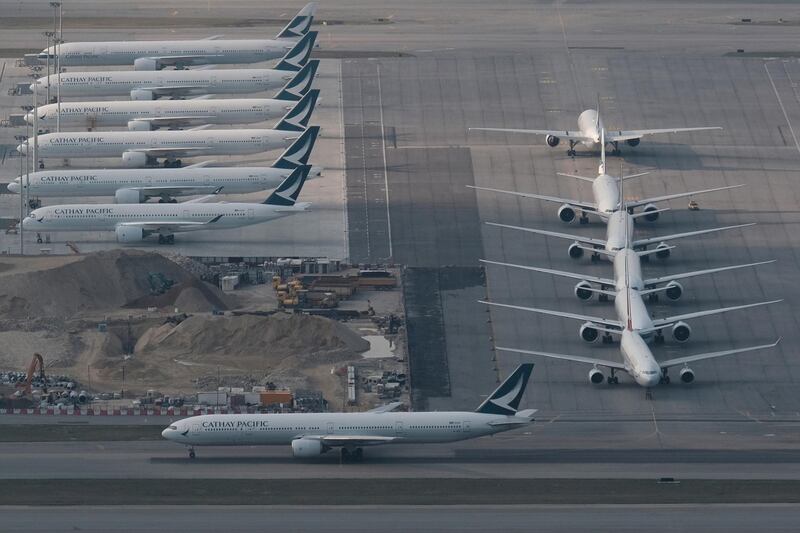 FILE PHOTO: FILE PHOTO-Cathay Pacific aircraft are seen parked on the tarmac at the airport, following the outbreak of the new coronavirus, in Hong Kong, China March 5, 2020. REUTERS/Tyrone Siu/File Photo