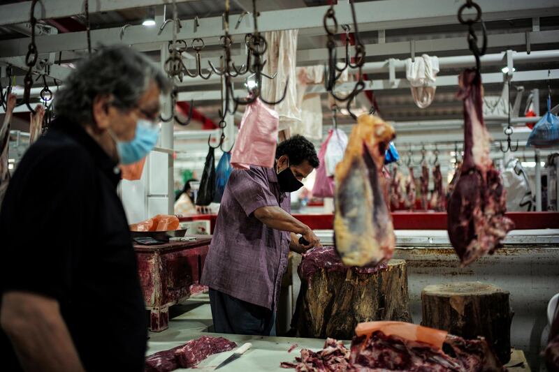 A butcher cuts meat at his stand, in Manama, Bahrain. Reuters