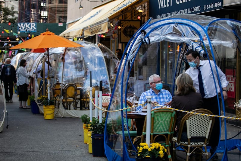 People sit outside Cafe Du Soliel under bubble tents in the Manhattan borough of New York City, New York, USA. Reuters