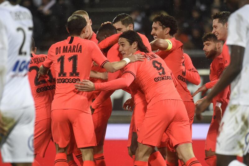 PSG's French defender Tanguy Kouassi (C) is congratulated by teammates after making it 3-2.  AFP