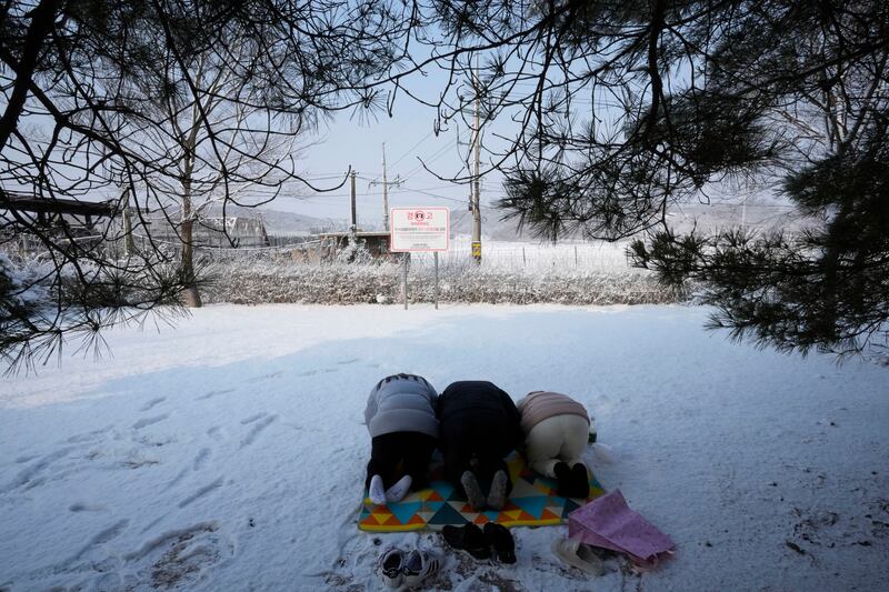 North Korean refugees bow to show respect for their ancestors as they visit the Imjingak Pavilion near the border with North Korea, to celebrate the Lunar New Year, in Paju, South Korea. AP