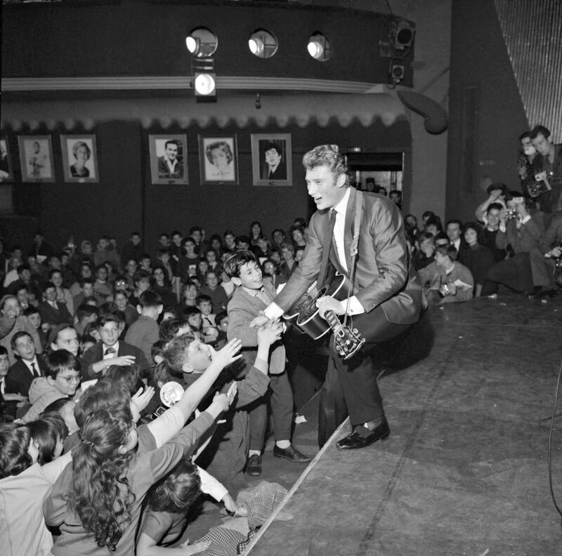 (FILES) In this file photo taken on December 13, 1962 French singer Johnny Hallyday performs a concert at the Olympia hall in Paris.
France's best-known rock star Johnny Hallyday has died aged 74 after a battle with lung cancer, his wife Laeticia told AFP on December 6, 2017. / AFP PHOTO / -