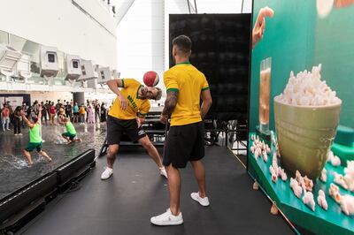 Freestyle footballer Lucas Menezes balances a ball on his neck in a performance at the Brazilian pavilion. Antonie Robertson / The National 

