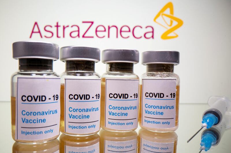 FILE PHOTO: Vials with a sticker reading, "COVID-19 / Coronavirus vaccine / Injection only" and a medical syringe are seen in front of a displayed AstraZeneca logo in this illustration taken October 31, 2020. REUTERS/Dado Ruvic/File Photo