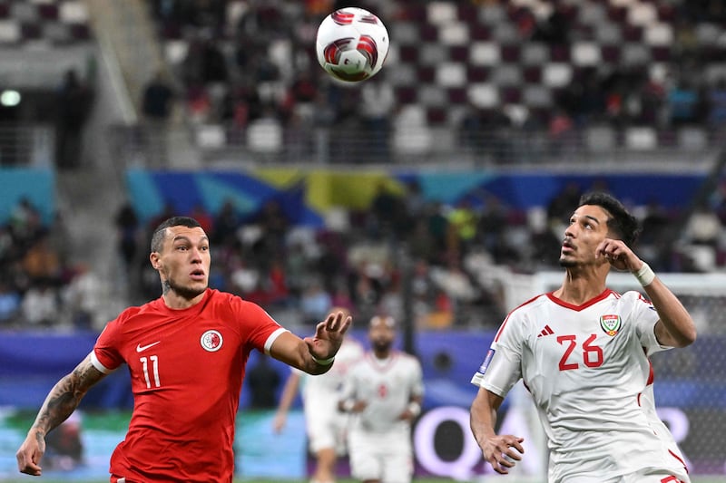 Hong Kong's forward Everton Camargo and UAE's defender Bader Nasser challenge for the ball. AFP