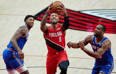 Jan 24, 2021; Portland, Oregon, USA; Portland Trail Blazers guard Damian Lillard (0) shoots over New York Knicks guard Elfrid Payton (6) and guard Alec Burks (18) during the first quarter at the Moda Center. Mandatory Credit: Craig Mitchelldyer-USA TODAY Sports