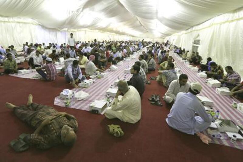 Caption ABU DHABI - UNITED ARAB EMIRATES - 14JULY2013 - Labourers waiting to break the fast at Sheikh Zayed Grand mosque on the Holy month Ramadan at Grand mosque yesterday in Abu Dhabi. Ravindranath K / The National

