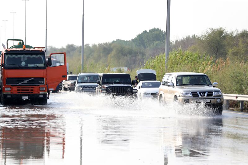 Cars move through floodwater in Al Qudra, Dubai. Chris Whiteoak / The National