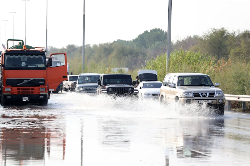Cars move through floodwater in Al Qudra, Dubai. Chris Whiteoak / The National