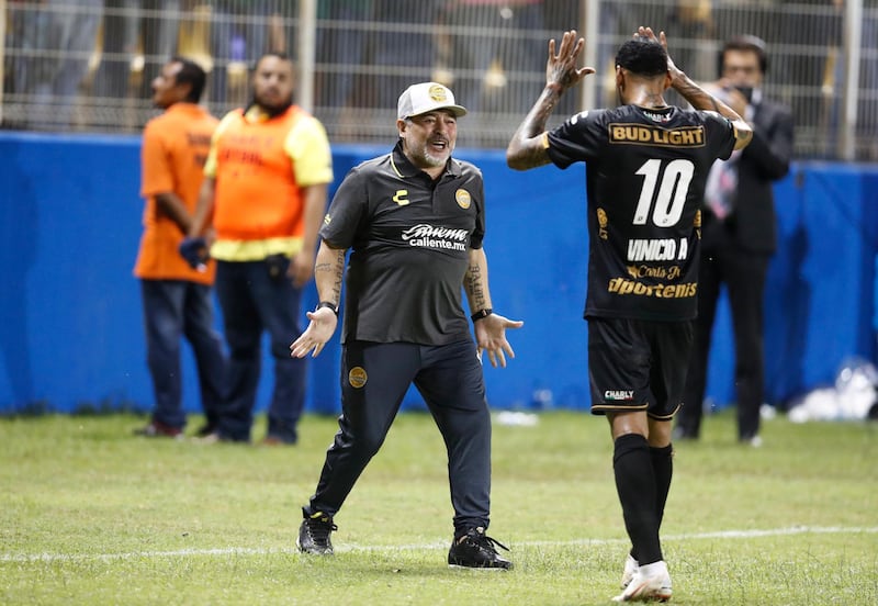 Maradona celebrates a goal by Gol Vinicio Angulo, right. AP Photo
