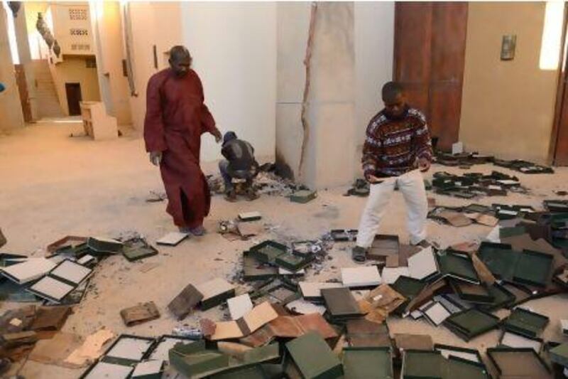 Men recover ancient manuscripts at the Ahmed Baba Institute in Timbutku that were burnt by militant Islamists last month.