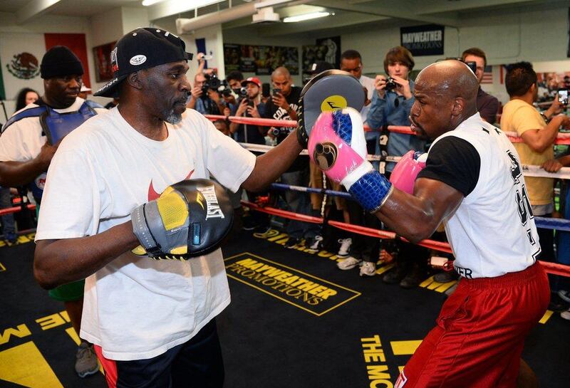 Floyd Mayweather spars with his uncle Roger Mayweather at the Mayweather Boxing Club on Tuesday. Ethan Miller / Getty Images / AFP / April 22, 2014