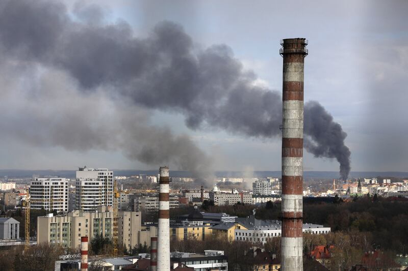 Smoke rises after military strikes in Lviv. Reuters