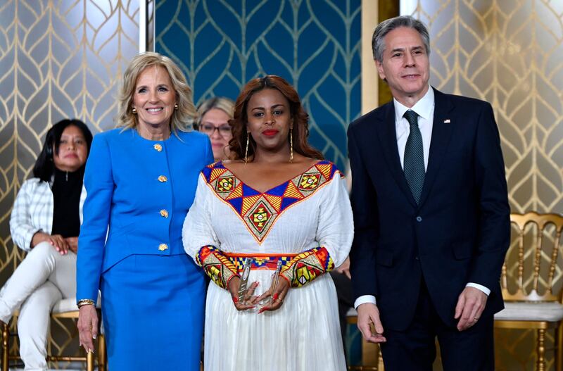 Ms Biden and Mr Blinken pose with Meaza Mohammed, an honouree from Ethiopia. AFP