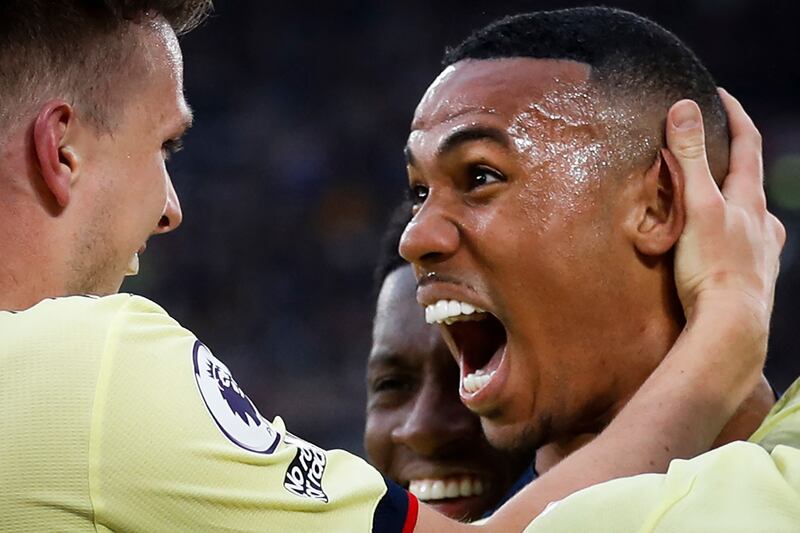 Arsenal's Brazilian defender Gabriel (R) celebrates with teammates after scoring a goal during the English Premier League football match between West Ham United and Arsenal at the London Stadium, in London on May 1, 2022.  (Photo by Ian Kington / IKIMAGES / AFP) / RESTRICTED TO EDITORIAL USE.  No use with unauthorized audio, video, data, fixture lists, club/league logos or 'live' services.  Online in-match use limited to 45 images, no video emulation.  No use in betting, games or single club/league/player publications. 