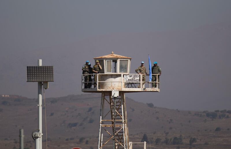 UNDOF Peacekeepers keep watch next to Quneitra crossing. EPA