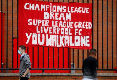 Soccer Football - Twelve of Europe's top football clubs launch a breakaway Super League - Liverpool, Britain - April 21, 2021   People walk past anti Super League banners outside Anfield as twelve of Europe's top football clubs launch a breakaway REUTERS/Phil Noble