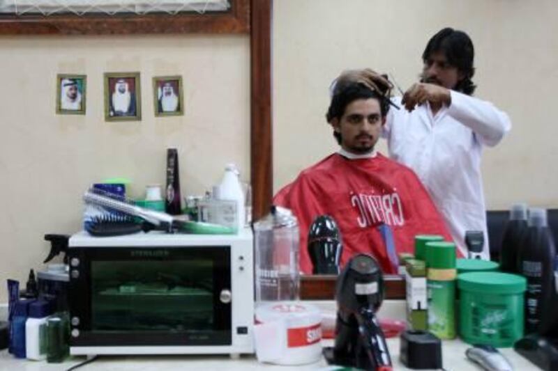 
DUBAI, UNITED ARAB EMIRATES Ð June 2, 2011: Irfan Sultan Ahmed cutting a customerÕs hair at his Silver Gents Salon in Al Barsha in Dubai. (Pawan Singh / The National) For News. Story by Bana
