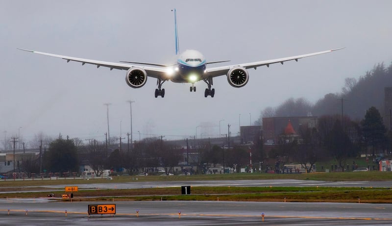 A Boeing 777X lands at Boeing Field in Seattle, after its first flight.  AP