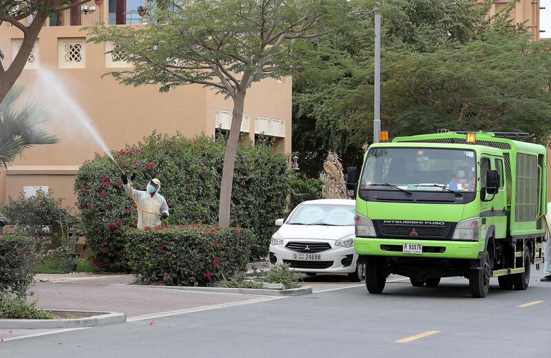 DUBAI, UNITED ARAB EMIRATES , April 11 – 2020 :- Dubai Municipality workers disinfecting the streets in Al Furjan area in Dubai. Dubai is conducting 24 hours sterilisation programme across all areas and communities in the Emirate and told residents to stay at home. UAE government told residents to wear face mask and gloves all the times outside the home whether they are showing symptoms of Covid-19 or not. (Pawan Singh/The National) For News/Online/Instagram/Standalone