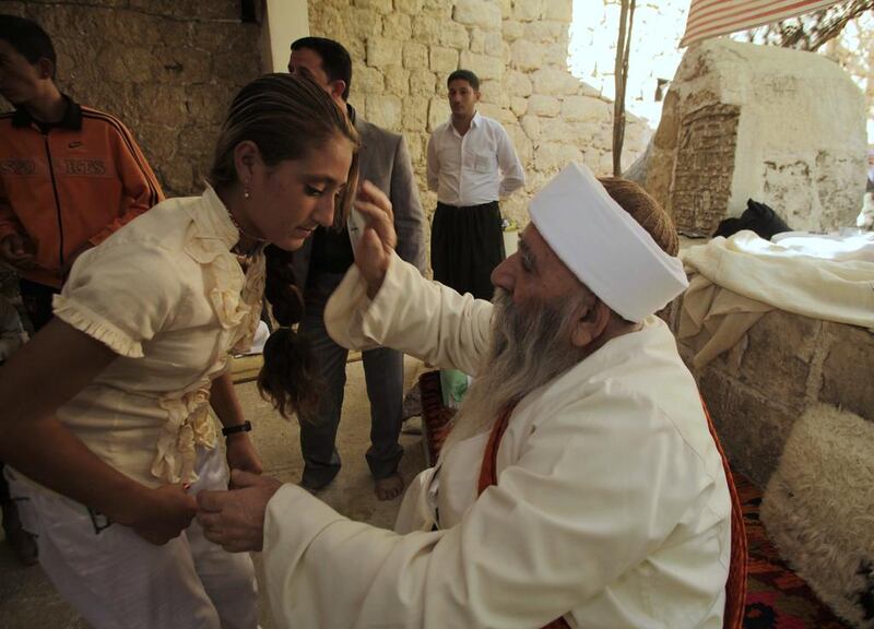 A Yazidi religious leader blesses a worshipper in northern Iraq, during the community’s main festival of Eid al-Jamma. Reuters
