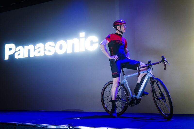 Edwin Bull, president and founder of Van Dessel NV, watches a presentation on a bicycle during a Panasonic event. Bloomberg